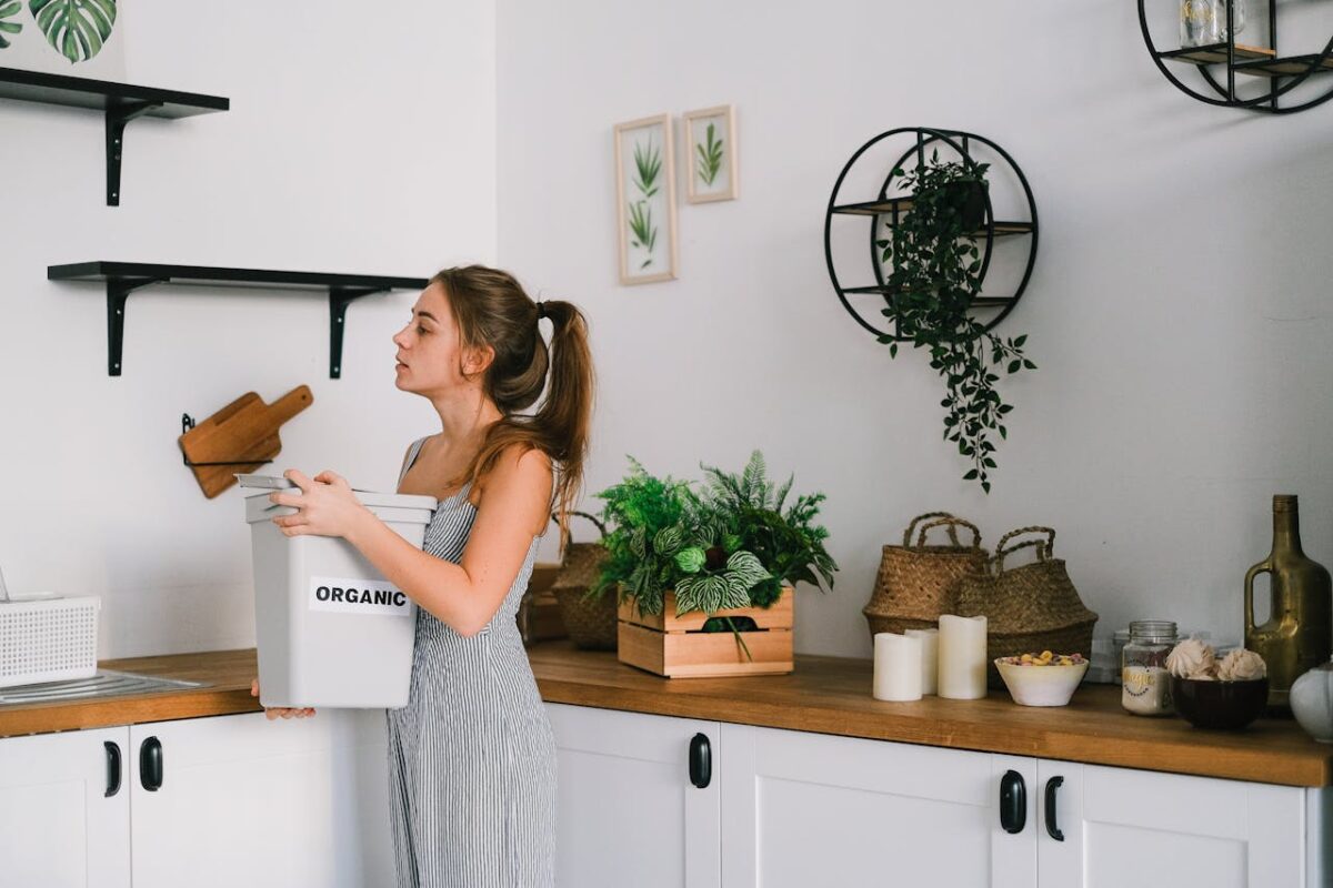 A woman sorting organic waste in a stylish kitchen promoting eco-friendly living.